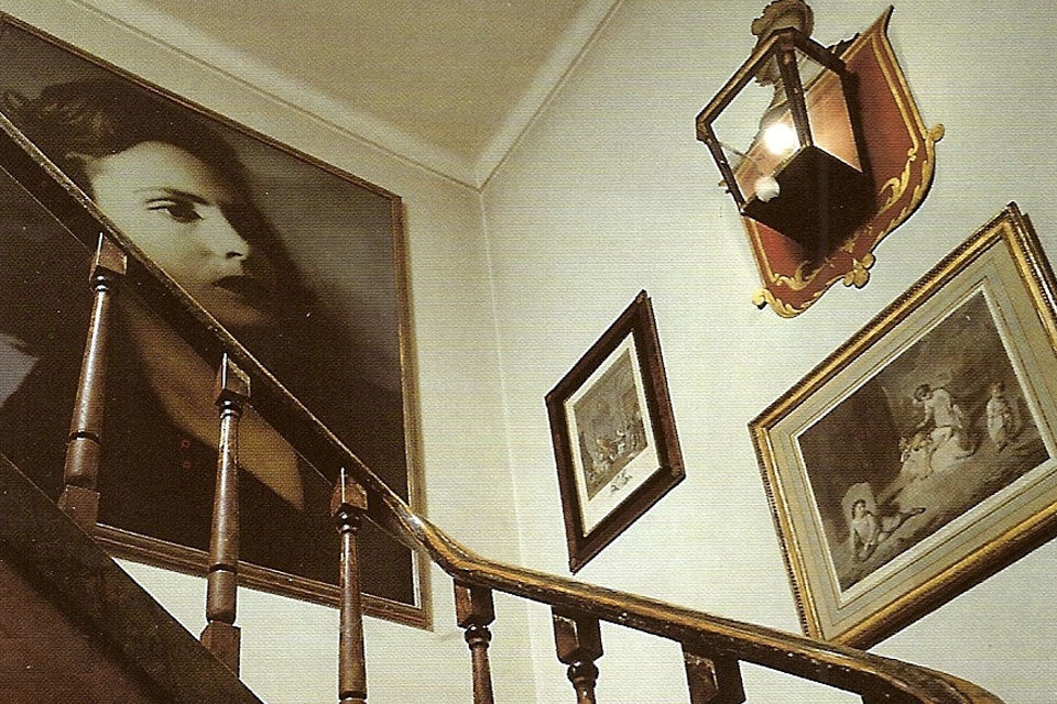 Staircase inside Amália Rodrigues House Museum with her portraits on the wall
