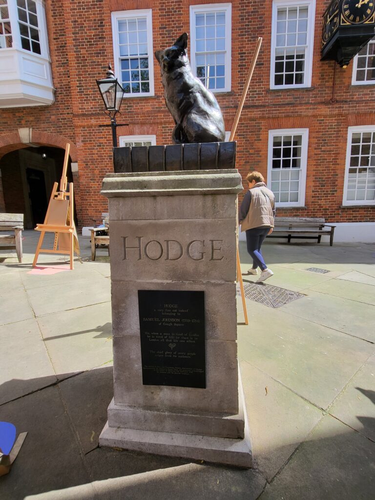 Bronze statue of Hodge the cat sitting on a dictionary with oyster shells outside Dr Johnson’s House in London
