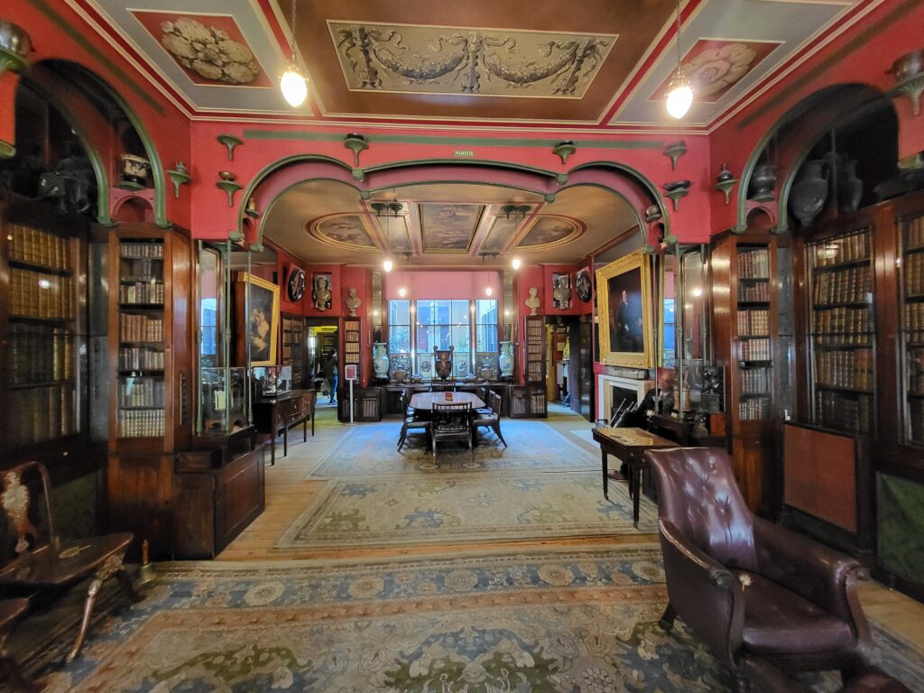 Historic library with bookcases, paintings and decorative ceiling at Sir John Soane's Museum in London