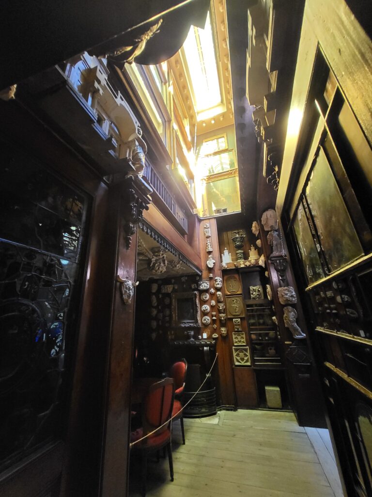 Historic interior with sculptures, paintings and coloured natural light inside Sir John Soane's Museum in London